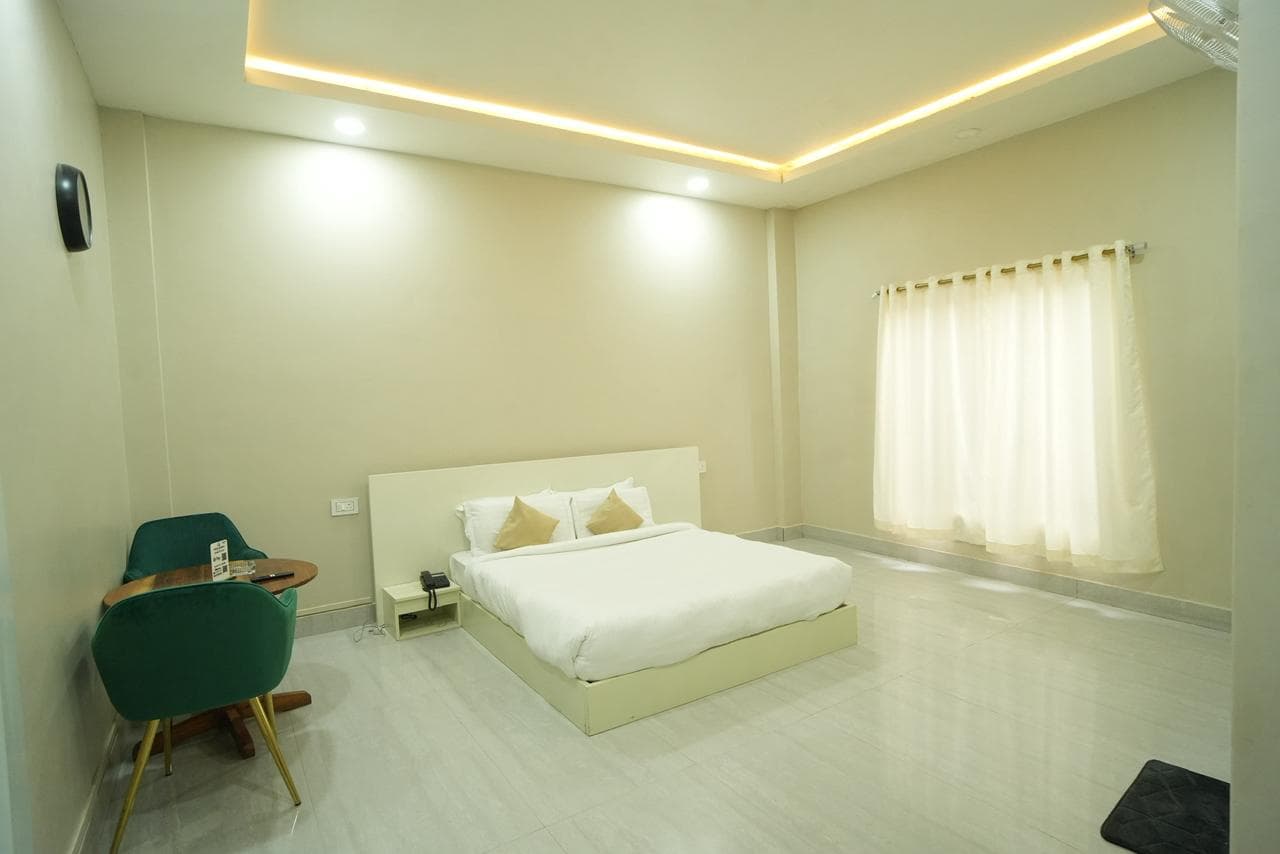 Single room with a neatly dressed bed and warm light